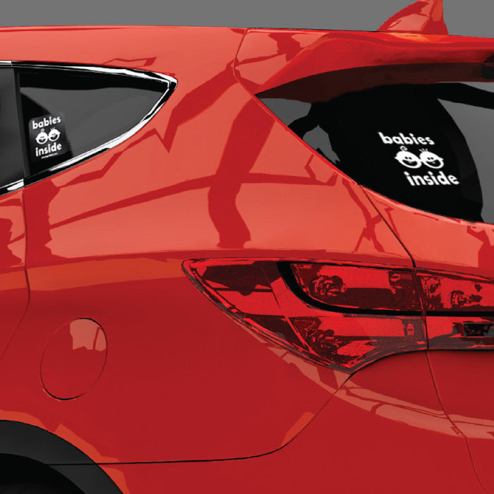 Close up of Babies Inside large white decal on rear tinted window and left side sticker on a red SUV.