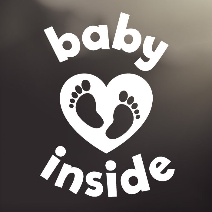 Large ‘Baby Inside Tiny Toes’ white vinyl, back window decal by Cheeky Pebble with baby feet inside a heart. Designed for placement on dark, tinted vehicle windows.