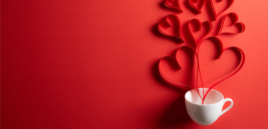 Picture of a white mug with paper hearts coming out of it like steam. Valentine's Day blog post