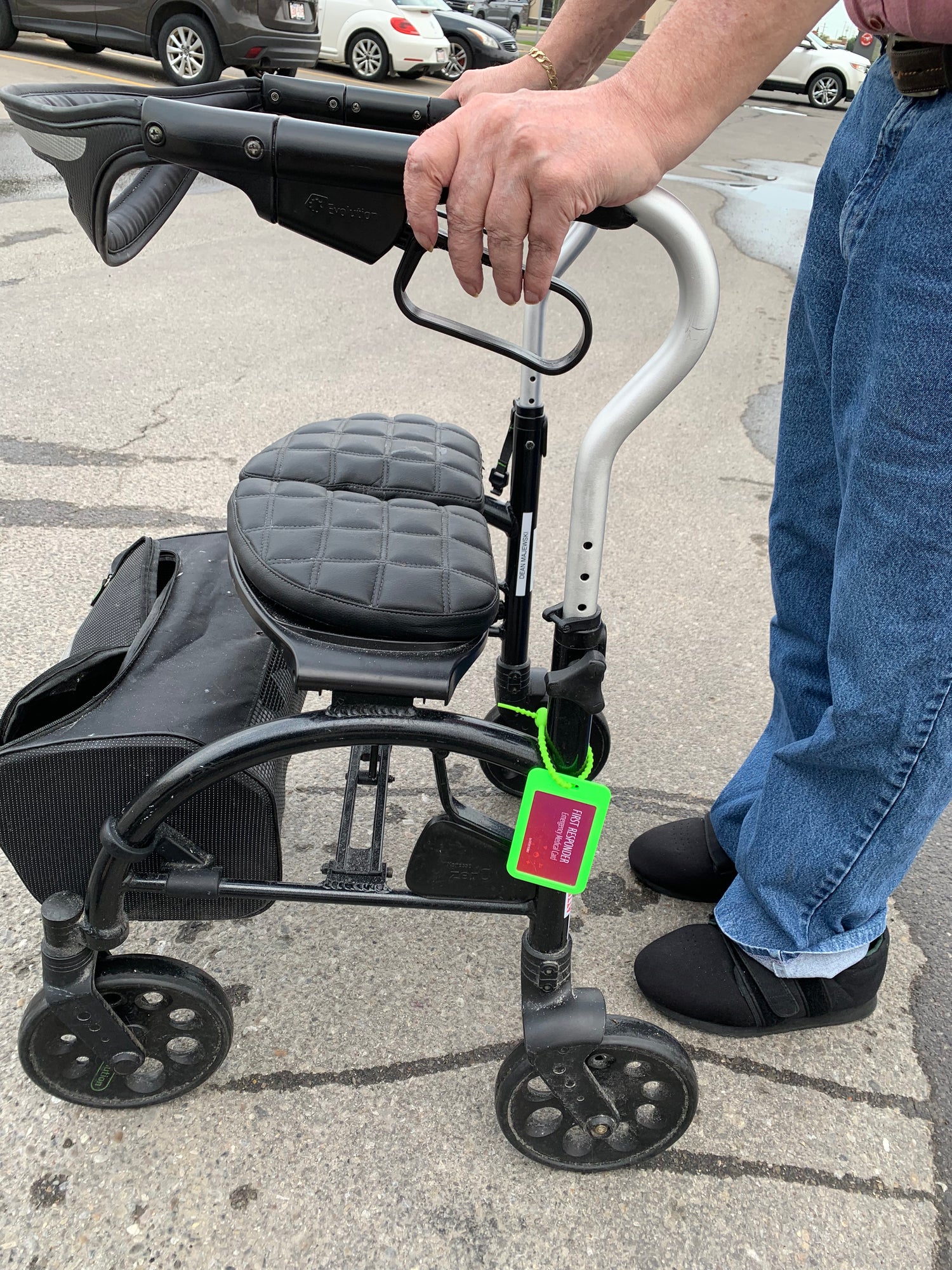 Image of an elderly adult using a green First Responder Emergency Card in their walker