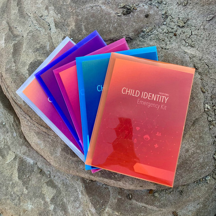 Image showing all 5 colours of the plastic sleeve of the Child Identity Emergency Kit. They come in clear, blue, purple, orange and pink. Only by Cheeky Pebble.