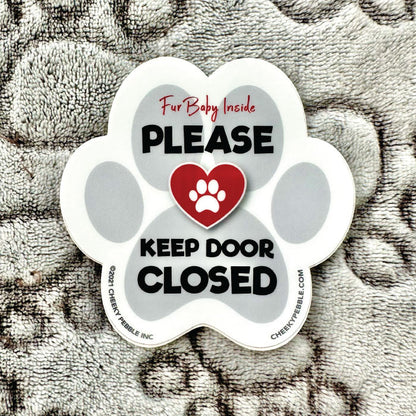 Picture of our Pet 'Keep Door Closed' sticker on a soft, paw patterned blanket