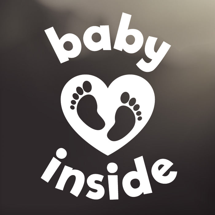 Large ‘Baby Inside Tiny Toes’ white vinyl, back window decal by Cheeky Pebble with baby feet inside a heart. Designed for placement on dark, tinted vehicle windows. 