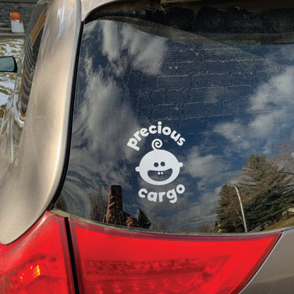 Picture of Precious Cargo back window decal on a tan minivan.