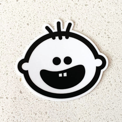 Cheeky Pebble Iconic Face Sticker on white countertop.